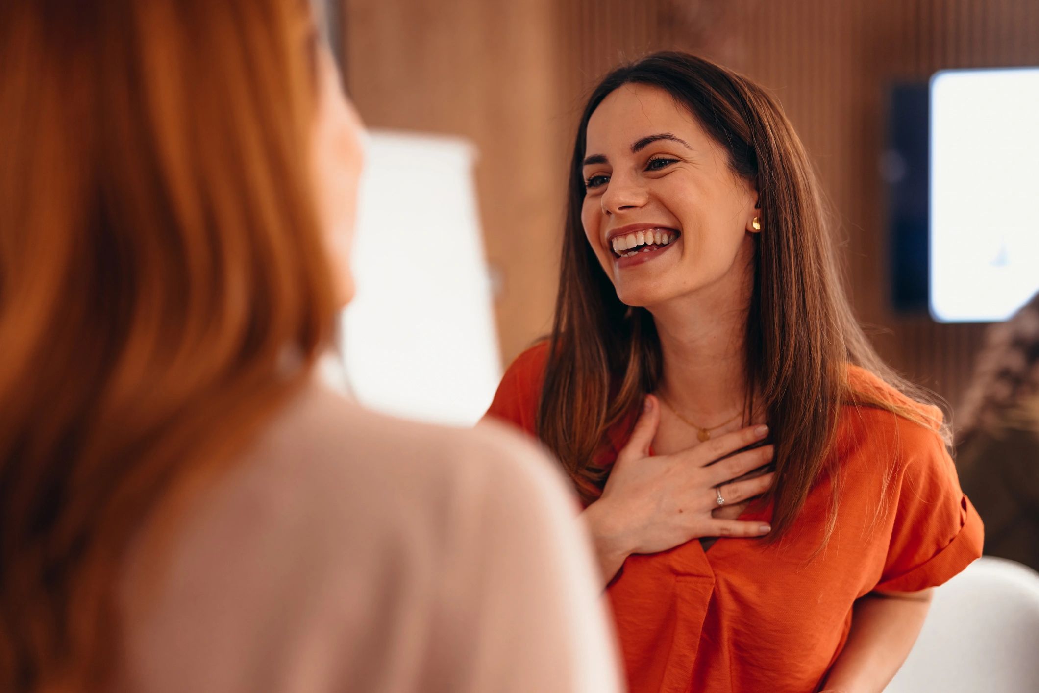 Two women in a warm coaching conversation